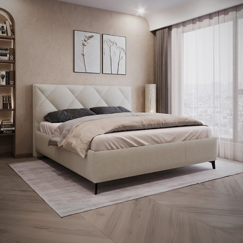 krémová čalúnená posteľ