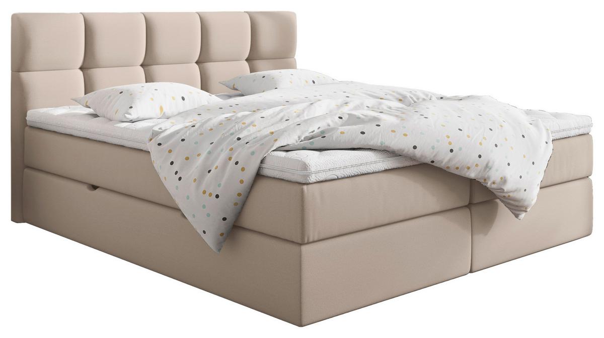 Boxspringbett mit cremefarbenem Bezug und gepolstertem Kopfteil