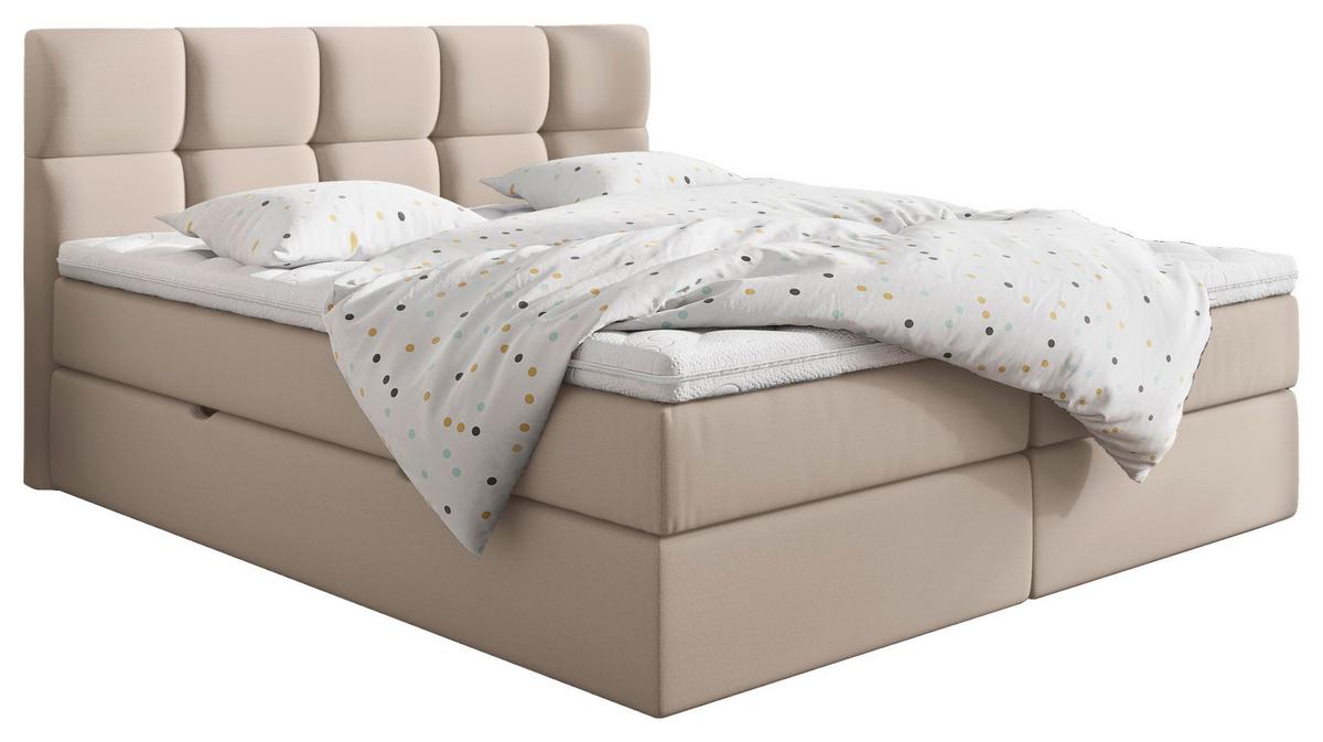Boxspringbett mit cremefarbenem Bezug und geposltertem Kopfteil