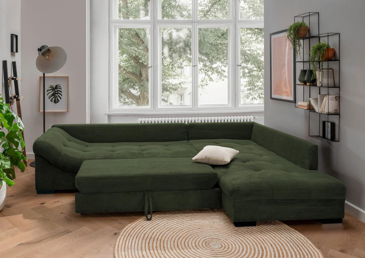 Dunkelgrünes Ecksofa mit Schlaffunktion sowie Rücken- und Zierkissen
