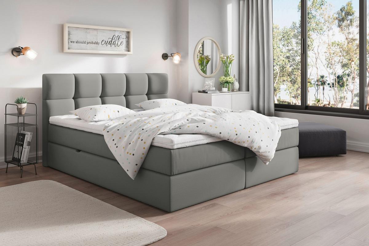 Graues Boxspringbett mit Matratze und durchgehendem Topper