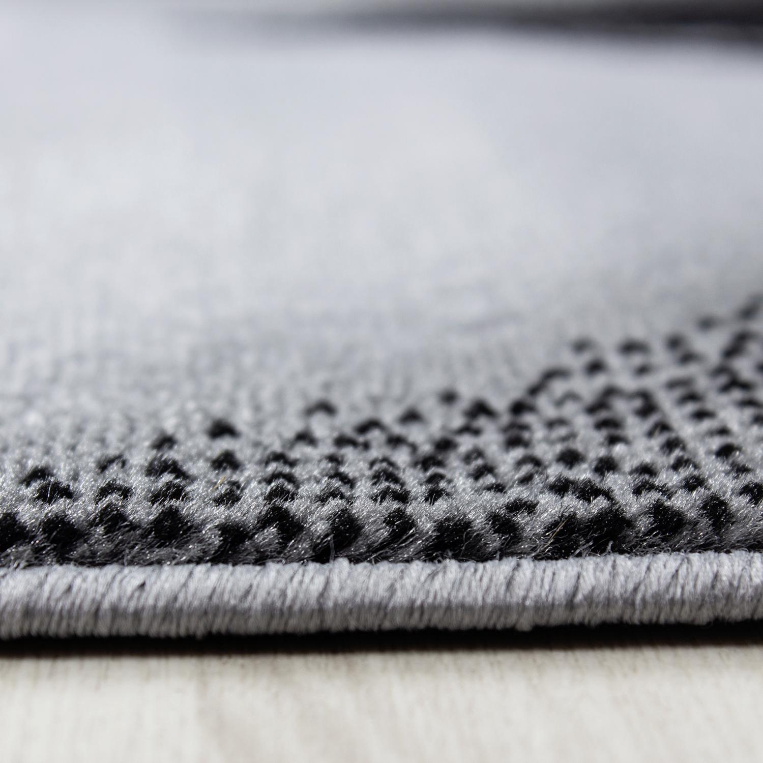 Schwarzer Webteppich mit Wellenmuster